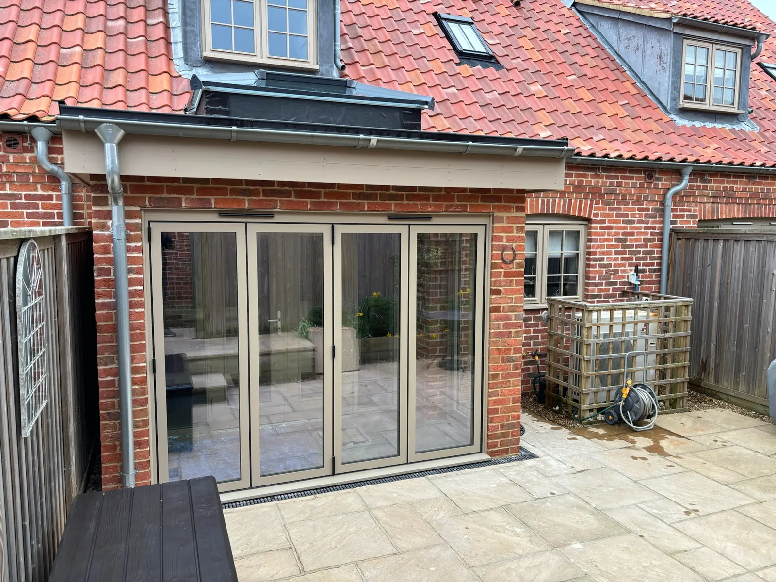 Wide glazed doors fitted to a brick extension